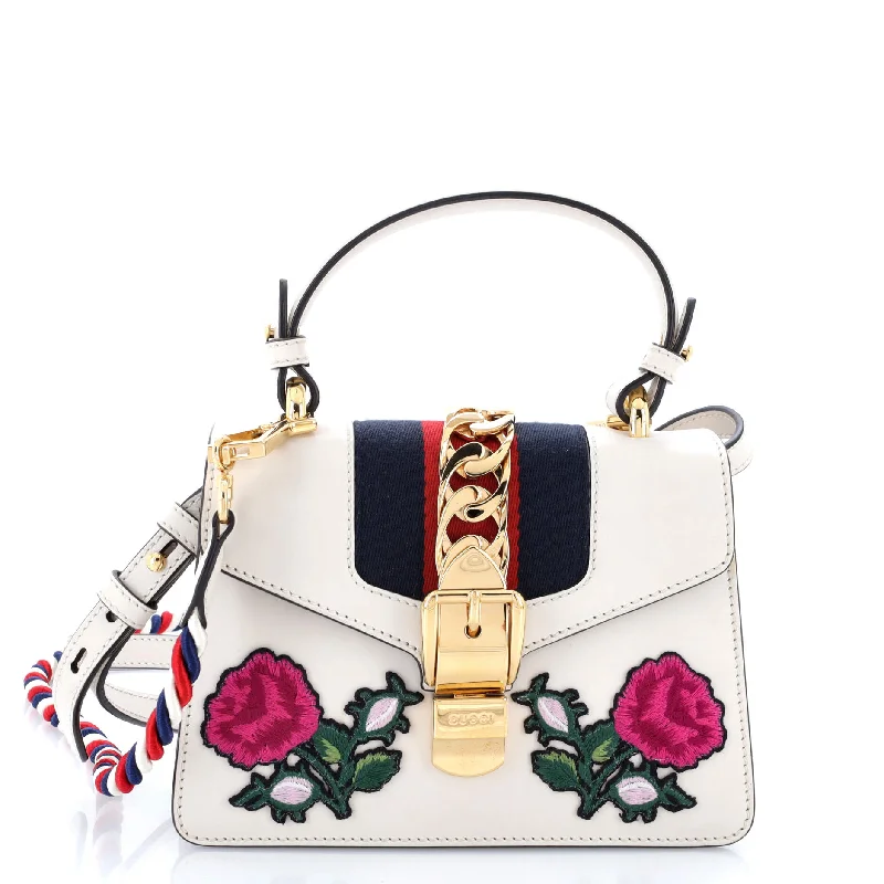 Women Gucci Sylvie bags with a monogram - embossed leatherSylvie Top Handle Bag Embroidered Leather Mini