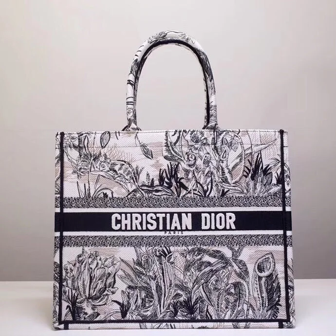 Christian Dior Saddle bags with a studded trim for a bold lookChristian Dior Book Tote Bag In Toile de Jouy Carnivora Motif