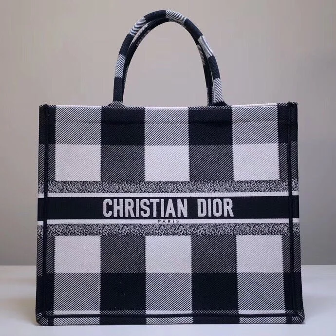 Christian Dior Saddle bags with a patent leather finish for a shiny lookChristian Dior Book Tote Bag In White/Black Check Embroidered Canvas